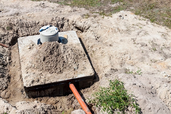 signs that your septic tank needs pumping include slow draining sinks, toilets, or showers, as well as a foul odor around the tank area